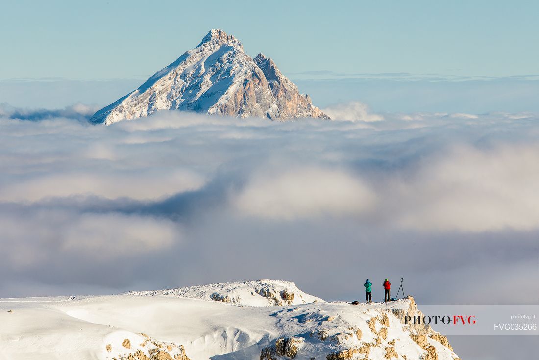 Photographers immortalise the Antelao mount rising from the sea of clouds, Cortina d'Ampezzo, dolomites, Italy, Europe Photographers immortalise the Antelao mount rising from the sea of clouds, Cortina d'Ampezzo, dolomites, Italy, Europe