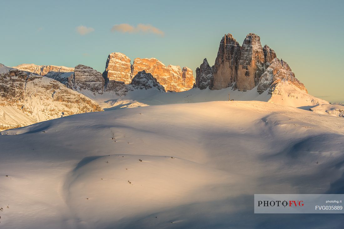 The summit cross of the Specie Mount and the Tre Cime di Lavaredo on background at sunset, Prato Piazza, Braies, Trentino Alto Adige, Italy, Europe