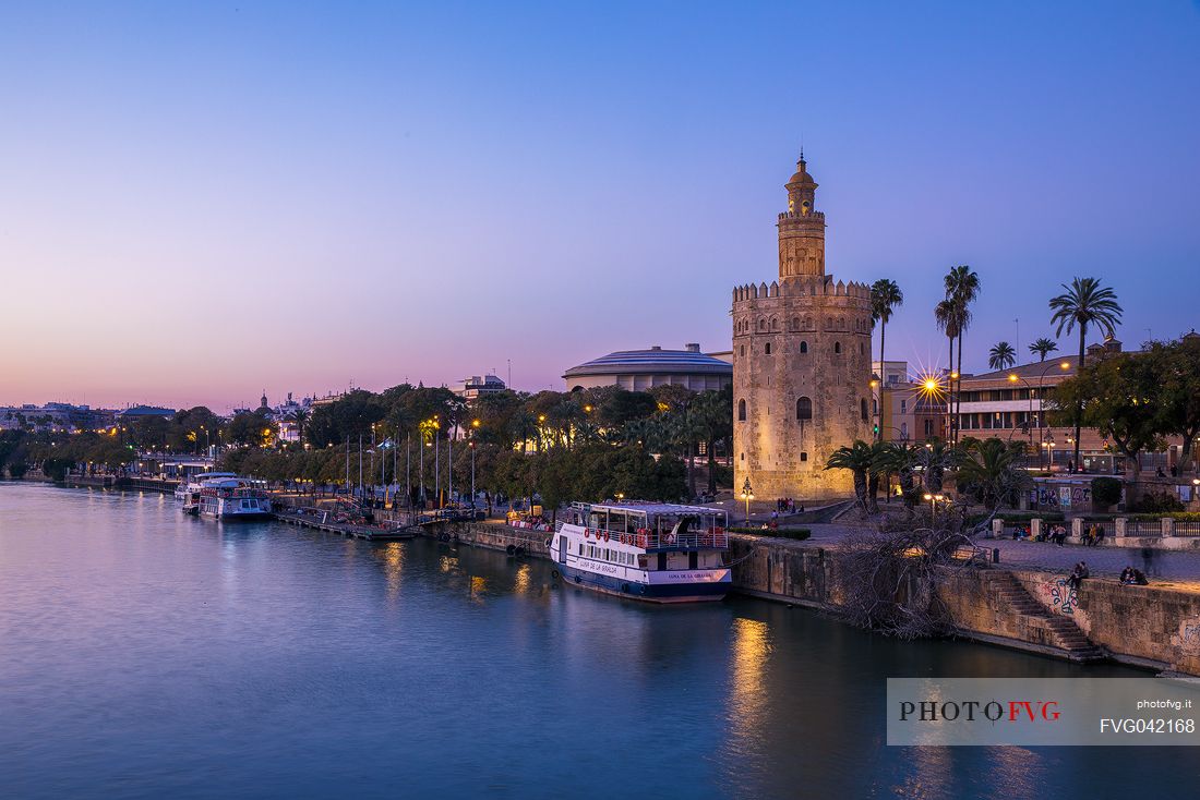The Guadalquivir river dominated by one of the most famous monuments of Seville, the Moorish Torre del Oro, Seville, Andalusia, Spain, Europe