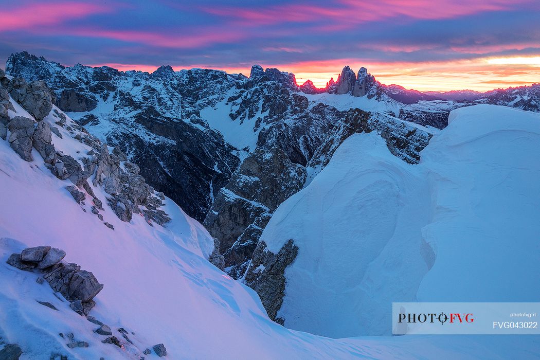 The Tre Cime di Lavaredo during a flaming dawn, photographed from the Picco di Vallandro over Prato Piazza valley in the Fanes Senes Braies natural park, dolomites, Pustertal, South Tyrol, Italy, Europe