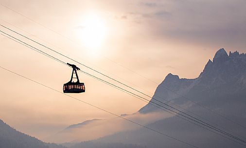 The Sesto's cableway rises to the Elmo mountain at sunrise