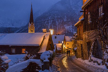 Walking in the snow in the picturesque streets of Hallstatt, the small village on the lake, Unesco Heritage form 1997