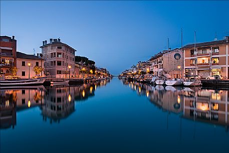 The port of Grado Vecchia is reflected in the lagoon at the blue hour