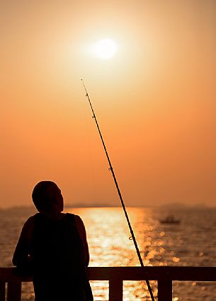 The wait of a fisherman during a summer sunrise