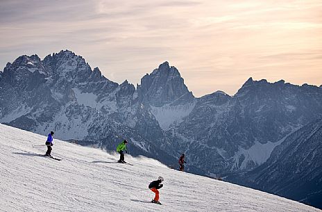 Skiers at the Elmo Mount with Sesto Dolomites in the background