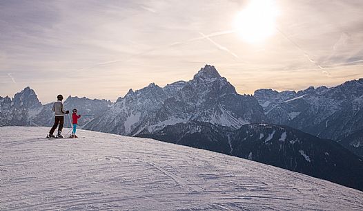 Sunset on the ski slopes of the Elmo mount with the Sesto Dolomites on background