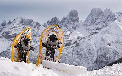 Snowshoes in the snow with the Piz Popena and Cristallo Mount on background