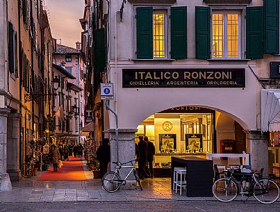 Via Mercato Vecchio lights in the evening , in the center of Udine