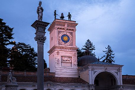 The clock tower and the column of Justice statue in Freedom Square in the historical center of Udine