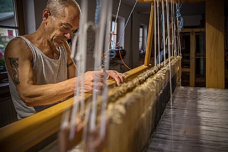 Hand weaver Herman Khebacher of Villabassa, the only one of South Tyrol using today still the traditional technique of weaving to handle and to use almost exclusively of natural fibers of wool and linen not treated with chemical products