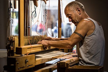 Hand weaver Herman Khebacher of Villabassa, the only one of South Tyrol using today still the traditional technique of weaving to handle and to use almost exclusively of natural fibers of wool and linen not treated with chemical products