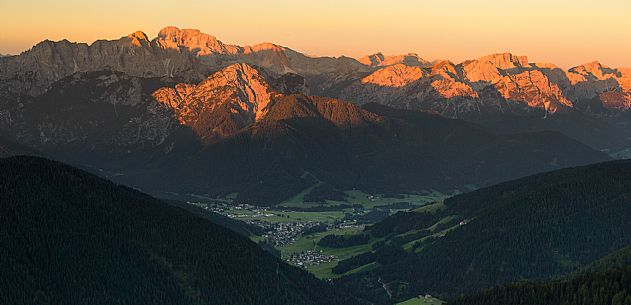 The village of Dobbiaco and the Braies Dolomites lit at dawn