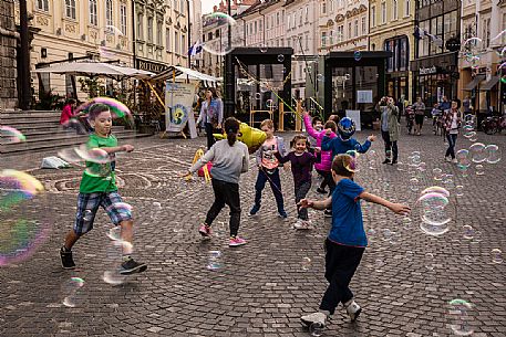 Children play with bubbles in the square in Lubiana, Slovenia, Europe Children play with bubbles in the square in Lubiana, Slovenia, Europe