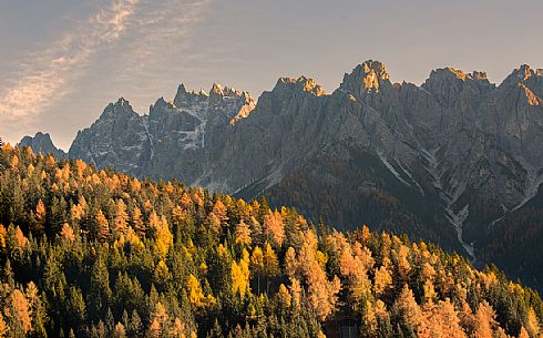 Golden larches and the group of Baranci on background from Dobbiaco