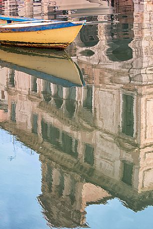 Palazzo Lisatti-Mascheroni reflected on the waters of the canal Vena, Chioggia, Italy