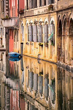 Old palaces reflected along the canal Vena, Chioggia, Italy 