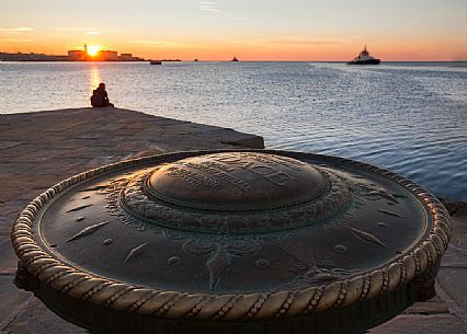 Compass rose or Rosa dei Venti and the port of Trieste at sunset from Molo Audace, Trieste, Italy
