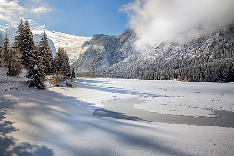 The Dobbiaco lake during a winter morning after a snowfall, Pusteria valley, Italy