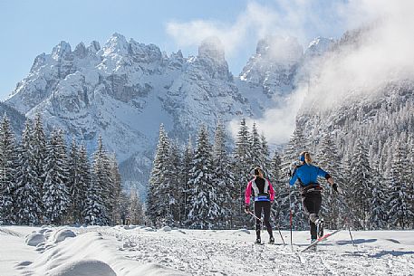 Cross country skiing in Cortina Dobbiaco trail, in the background the Piz Popena and Cristallo Mount, Pusteria valley, Italy Cross country skiing in Cortina Dobbiaco trail, in the background the Piz Popena and Cristallo Mount, Pusteria valley, Italy