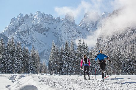 Cross country skiing in Cortina Dobbiaco trail, in the background the Piz Popena and Cristallo Mount, Pusteria valley, Italy