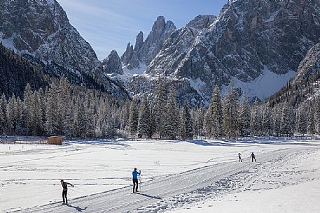 Ski cross immersed in the winter landscape of Tre Cime di Lavaredo Natural Park, Sesto, dolomites, italy