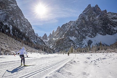 Ski cross immersed in the winter landscape of Tre Cime di Lavaredo Natural Park, Sesto, dolomites, italy Ski cross immersed in the winter landscape of Tre Cime di Lavaredo Natural Park, Sesto, dolomites, italy
