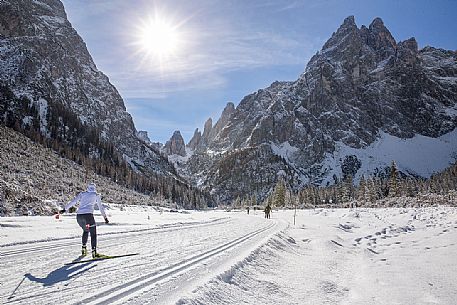 Ski cross immersed in the winter landscape of Tre Cime di Lavaredo Natural Park, Sesto, dolomites, italy