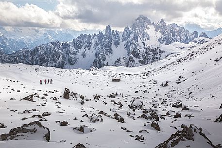 Hikers along the path leading to the Auronzo refuge in Tre Cime Natural Park, dolomites, Italy