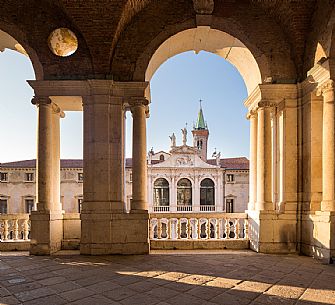 Architecture of the Loggia of the Basilica Palladiana, on background the Monte Pietà Palace, Vicenza, Italy