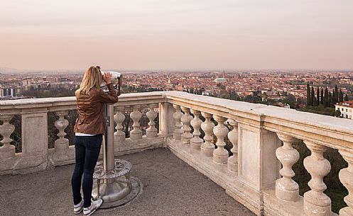 Tourist admires the city of Vicenza from the square of the Basilica of Monte Berico, Vicenza, Italy