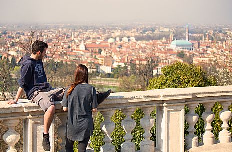 Couple of guys admires the view from the square of the Sanctuary of Monte Berico, Vicenza, Italy