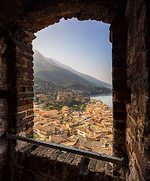 The small medieval village of Malcesine on Garda lake framed by the castle walls of Scaligero, Italy