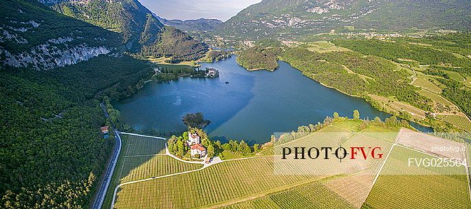 View from above of Toblino Lake with the homonymous castle, in the foreground the historic Toresella farm, Valley of Lakes, Trentino, Italy
