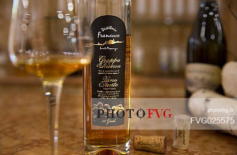 Bottle and glass of Vino Santo of the distillery of Francesco Poli in Santa Massenza, Valley of Lakes, Trentino, Italy Bottle and glass of Vino Santo of the distillery of Francesco Poli in Santa Massenza, Valley of Lakes, Trentino, Italy