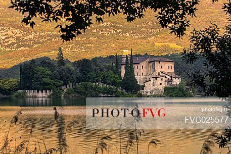 The Toblino Castle reflects on the waters of the homonymous lake, Valley of Lakes, Valle dei Laghi, Trentino, Italy