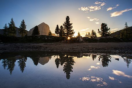 The Tofana di Rozes reflected on the little pond of Limedes during a sunrise, Cortina D'Ampezzo, Dolomites, Italy