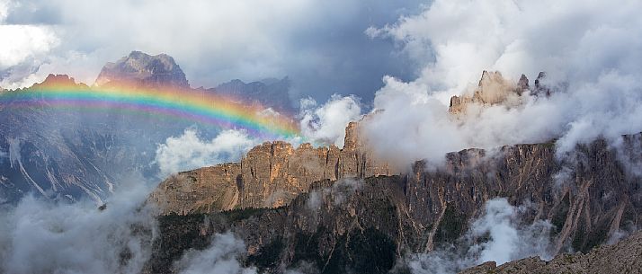 An intense rainbow stands out in front of the Sorapis after a strong thunderstorm with the Croda Da Lago wrapped in the clouds in the foreground, Dolomites, Cortina D'Ampezzo, Italy An intense rainbow stands out in front of the Sorapis after a strong thunderstorm with the Croda Da Lago wrapped in the clouds in the foreground, Dolomites, Cortina D'Ampezzo, Italy