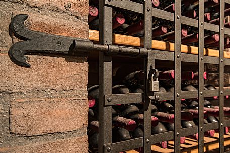 Bottles of wine in the the historic aging cellar of Castello di Spessa in Capriva del Friuli, Friuli Venezia Giulia, Italy