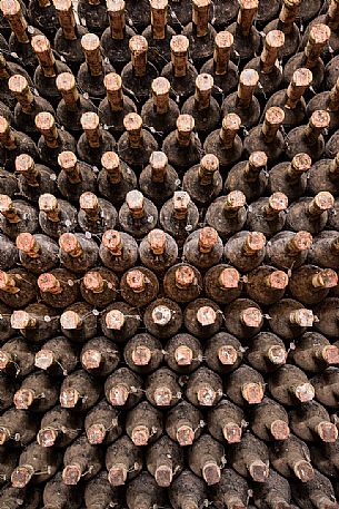 Aged bottles of the historic aging cellar of Castello di Spessa castle in Capriva del Friuli, Friuli Venezia Giulia, Italy Aged bottles of the historic aging cellar of Castello di Spessa castle in Capriva del Friuli, Friuli Venezia Giulia, Italy