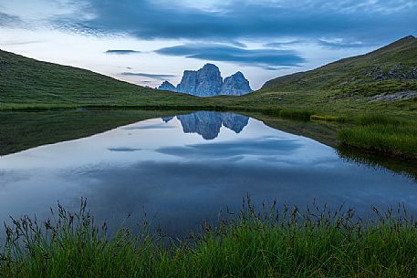 Pelmo mount reflected on Baste lake at twilight, Mondeval, Dolomites, Italy