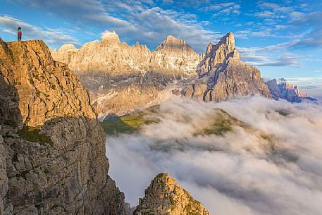 The northern chain of the Pale di San Martino over a cloud of clouds photographed from the top of the path of Cristo Pensante, Trentino Alto Adige, Dolomites, Italy