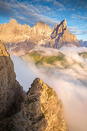 The northern chain of the Pale di San Martino over a cloud of clouds photographed from the top of the path of Cristo Pensante, Dolomites, San Martino di Castrozza, Italy