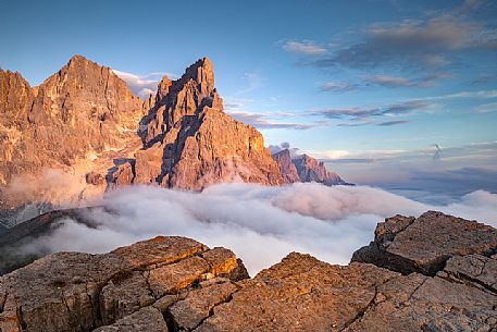 The northern chain of the Pale di San Martino over a cloud of clouds photographed from the top of the path of Cristo Pensante, Dolomites, San Martino di Castrozza, Italy