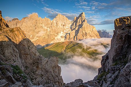 The northern chain of the Pale di San Martino over a cloud of clouds photographed from the top of the path of Cristo Pensante, Dolomites, San Martino di Castrozza, Italy