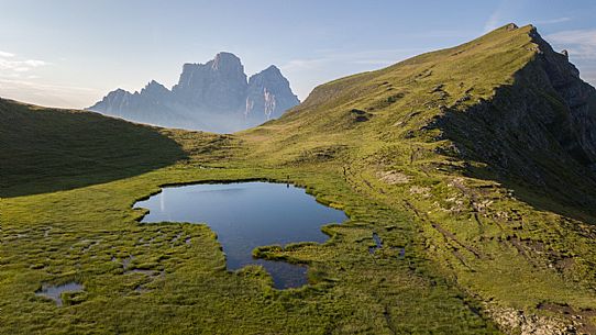 Pelmo Mount, Baste lake and the meadows of Mondeval during a summer morning, Dolomites, Italy Pelmo Mount, Baste lake and the meadows of Mondeval during a summer morning, Dolomites, Italy