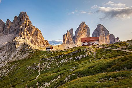 Tre Cime di Lavaredo, Locatelli refuge and the Paterno Mount illuminated by sunset, Dolomites, South Tyrol, Italy