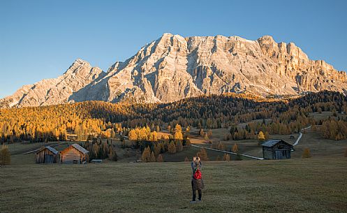 Tourist photographs the autumnal Armentara meadows in the Fanes Senes Braies natural park, Val Badia, Trentino Alto Adige, Italy Tourist photographs the autumnal Armentara meadows in the Fanes Senes Braies natural park, Val Badia, Trentino Alto Adige, Italy