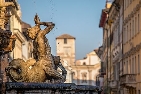 Detail of the fountain of Nettuno, on background the church of San Francesco Saverio, Trento, Trentino Alto Adige, Italy