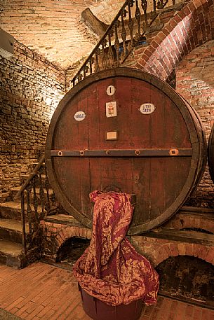 Wooden barrel in the historic wine cellar of Casa E. di Mirafiore e Fontanafredda in Serralunga d'Alba, Langhe, Piedmont, Italy, Europe