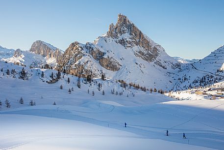 Skiers on the slopes of the Falzarego Pass and in the background the Sass de Stria mount, Cortina d'Ampezzo, dolomites, Veneto, Italy, Europe Skiers on the slopes of the Falzarego Pass and in the background the Sass de Stria mount, Cortina d'Ampezzo, dolomites, Veneto, Italy, Europe